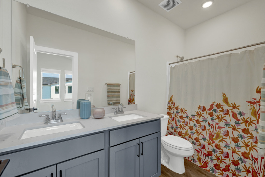 a bathroom with a shower curtain and sink