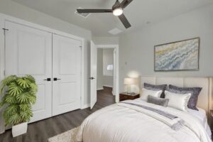 a bedroom with a bed and a fan