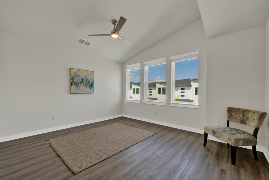 a room with a fan and a rug