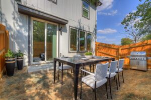 a table and chairs outside of a house
