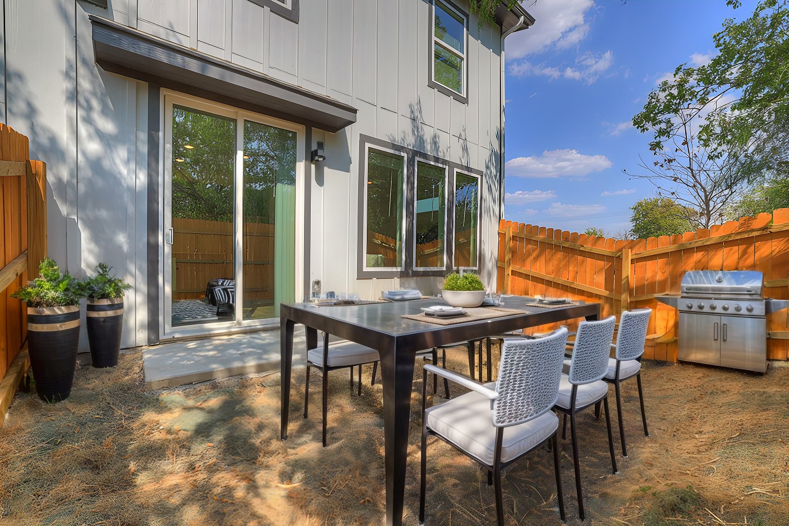a table and chairs outside of a house