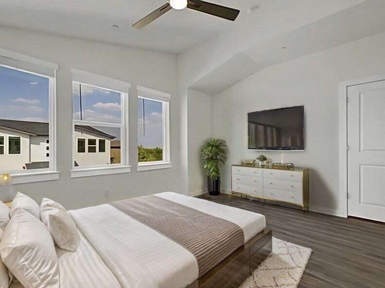 a bedroom with a large bed and a television